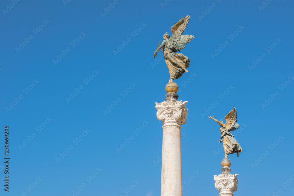 Winged woman statue in front of Altare della Patria, Piazza Venezia, Rome Italy