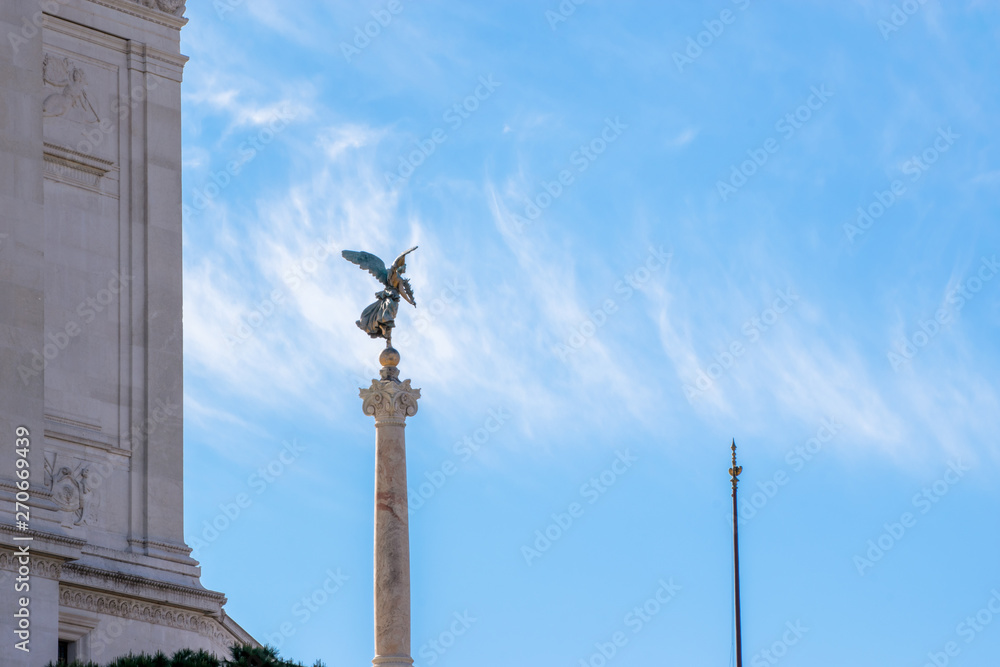 Winged woman statue in front of Altare della Patria, Piazza Venezia, Rome Italy
