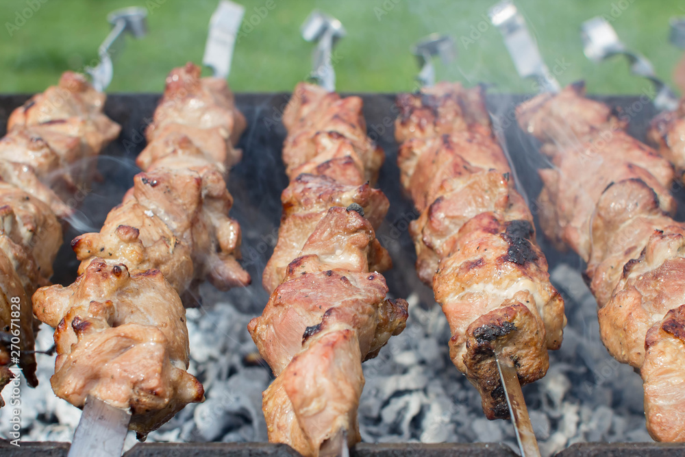 Shashlik pork on skewers close up. Meat roasted on an open fire on the grill. Selective focus. Shashlik pork on skewers close up. Meat roasted on an open fire on the grill. Selective focus.