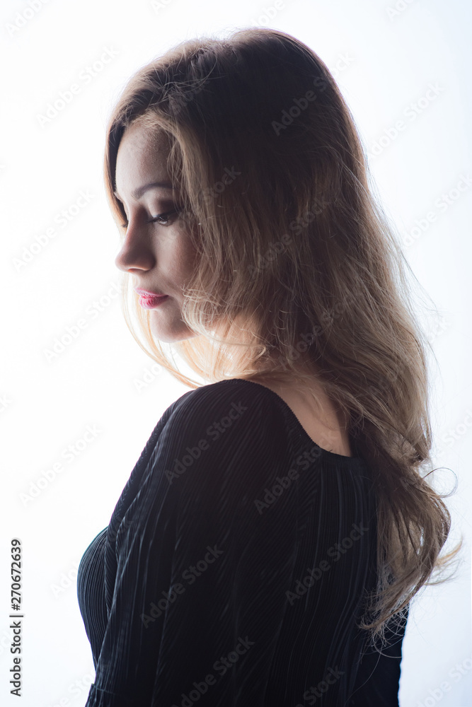Beautiful ,young blonde with bright red lips and expressive eyes in a black jumpsuit. Beauty portrait of a girl. Emotional and bright appearance. Fashion portrait of a woman. Beautiful ,young blonde with bright red lips and expressive eyes in a black jumpsuit. Beauty portrait of a girl. Emotional and bright appearance. Fashion portrait of a woman.