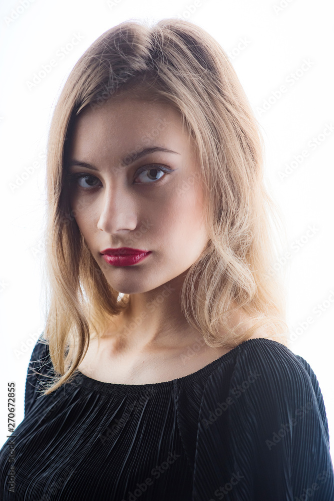 Beautiful ,young blonde with bright red lips and expressive eyes in a black jumpsuit. Beauty portrait of a girl. Emotional and bright appearance. Fashion portrait of a woman. Beautiful ,young blonde with bright red lips and expressive eyes in a black jumpsuit. Beauty portrait of a girl. Emotional and bright appearance. Fashion portrait of a woman.