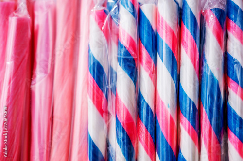 Close-up of colorful sugar sticks, sweet temptation in bright, fresh colors, sugary aromas, on a street market. photo