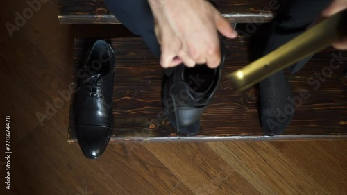 Man put on black shoes photo