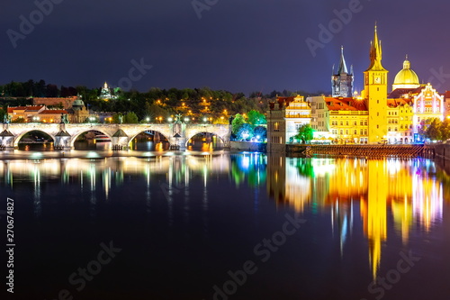 Prague architecture and Charles bridge over Vltava river at night, Czech Republic