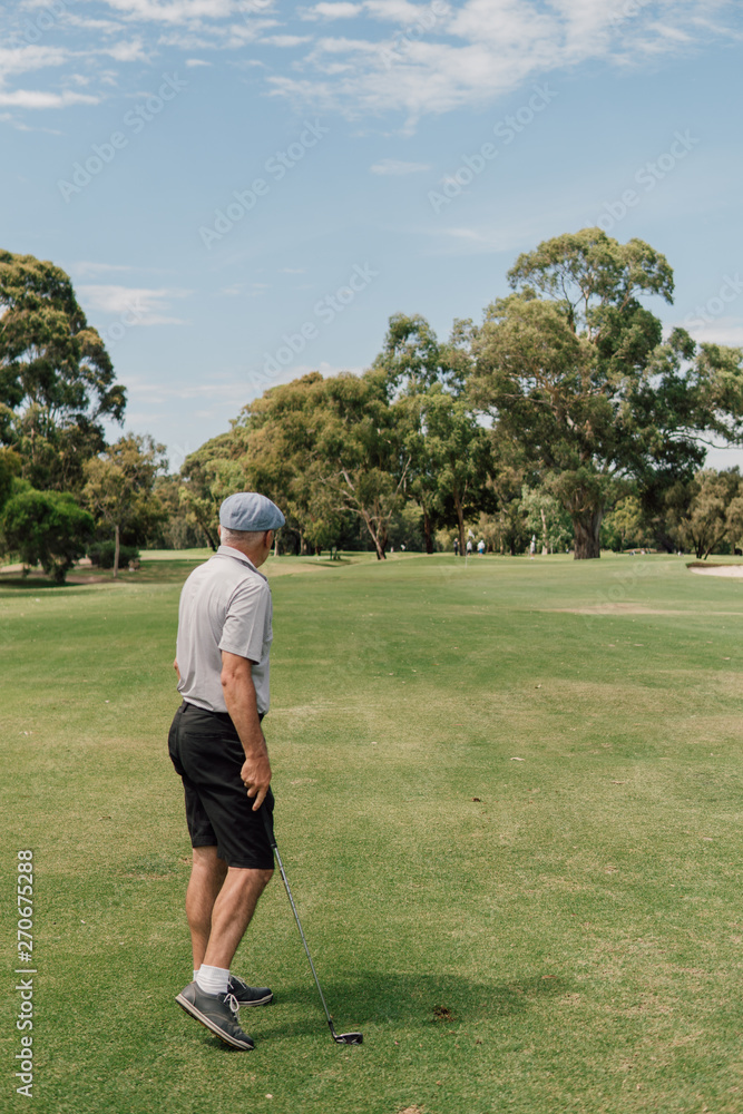 Senior man playing golf on the public golf course Senior man playing golf on the public golf course