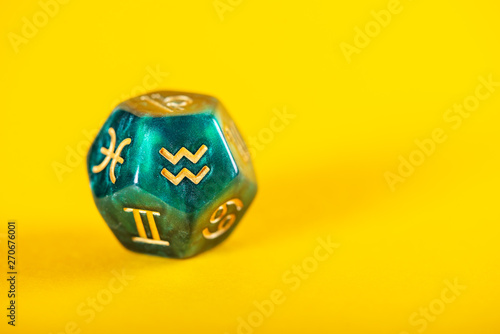 Astrology Dice with zodiac symbol of Aquarius Jan 20 - Feb 18 on Yellow Background photo