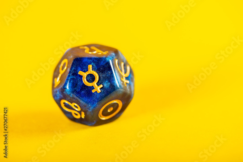Astrology Dice with symbol of the planet Mercury on Yellow Background