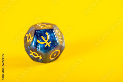 Astrology Dice with symbol of the planet Neptune on Yellow Background photo