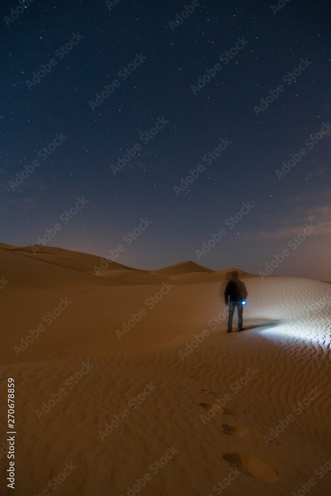 Man walking alone in the middle of the desert Man walking alone in the middle of the desert