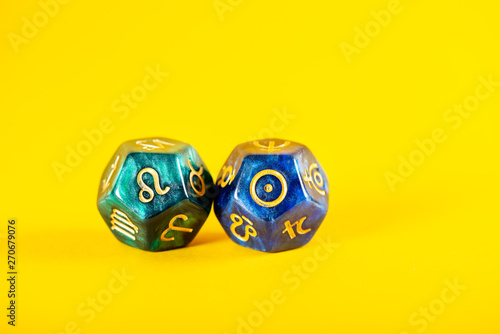 Astrology Dice with zodiac symbol of Leo Jul 23 - Aug 22 and its ruling celestial body the Sun on Yellow Background