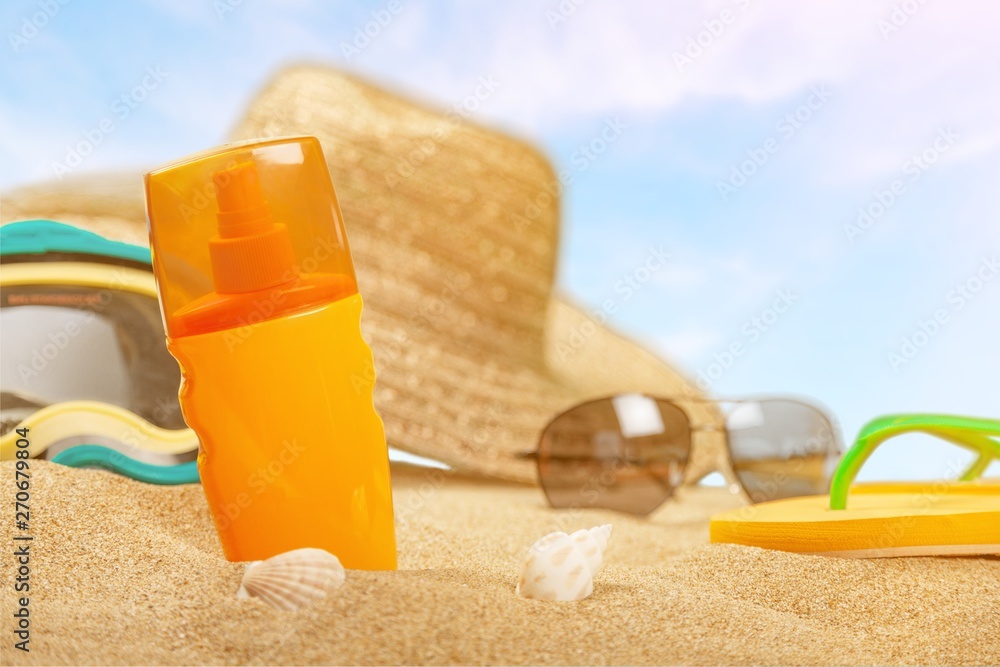 Bottle of sunscreen lotion on the sandy beach Bottle of sunscreen lotion on the sandy beach
