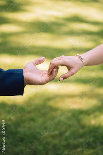 young couple puts on wedding rings. boy and girl hold hands. married couple. © Stanislav