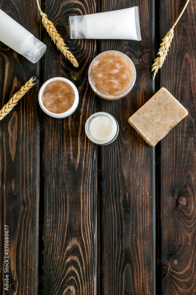 Cosmetics with natural herbal and wheat ingredients on wooden background top view copyspace Cosmetics with natural herbal and wheat ingredients on wooden background top view copyspace