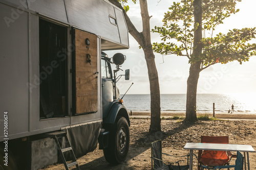 camping truck at the beach at sunset photo