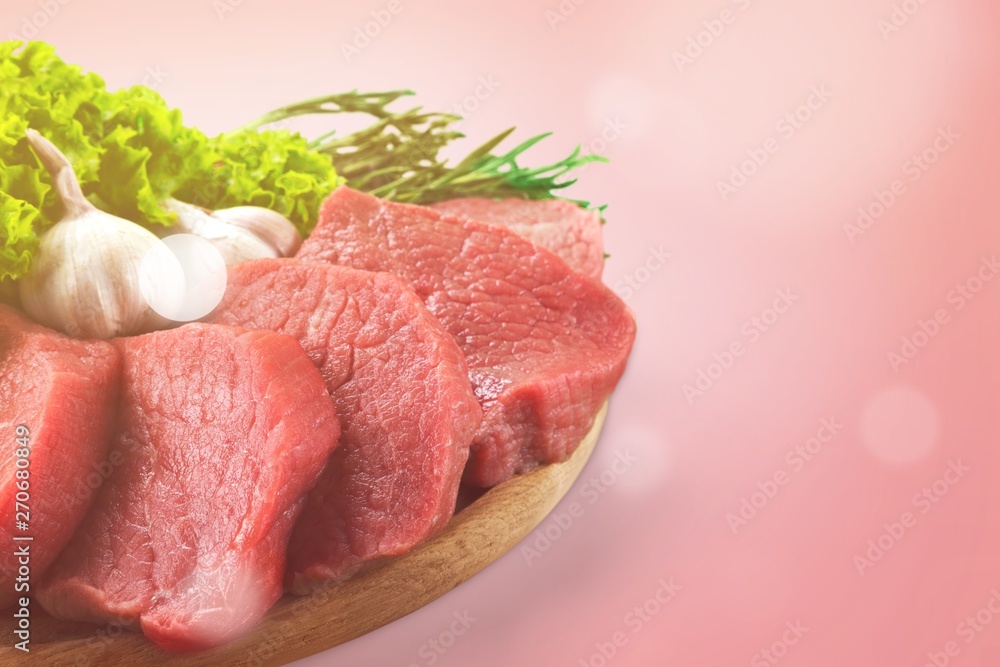 Slices of raw meat with lettuce and garlic Slices of raw meat with lettuce and garlic