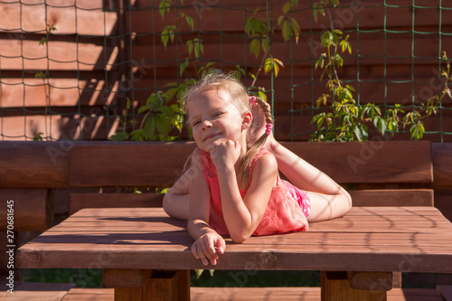 girl lying on the table in wooden arbor