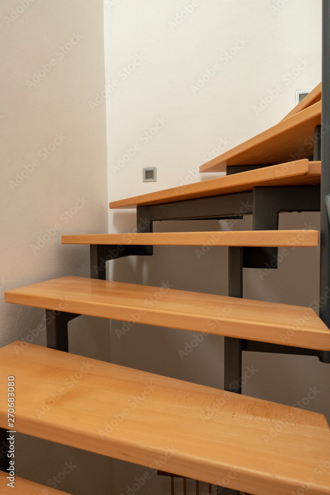 Obraz premium design wooden staircase with steel construction and white walls in a new house