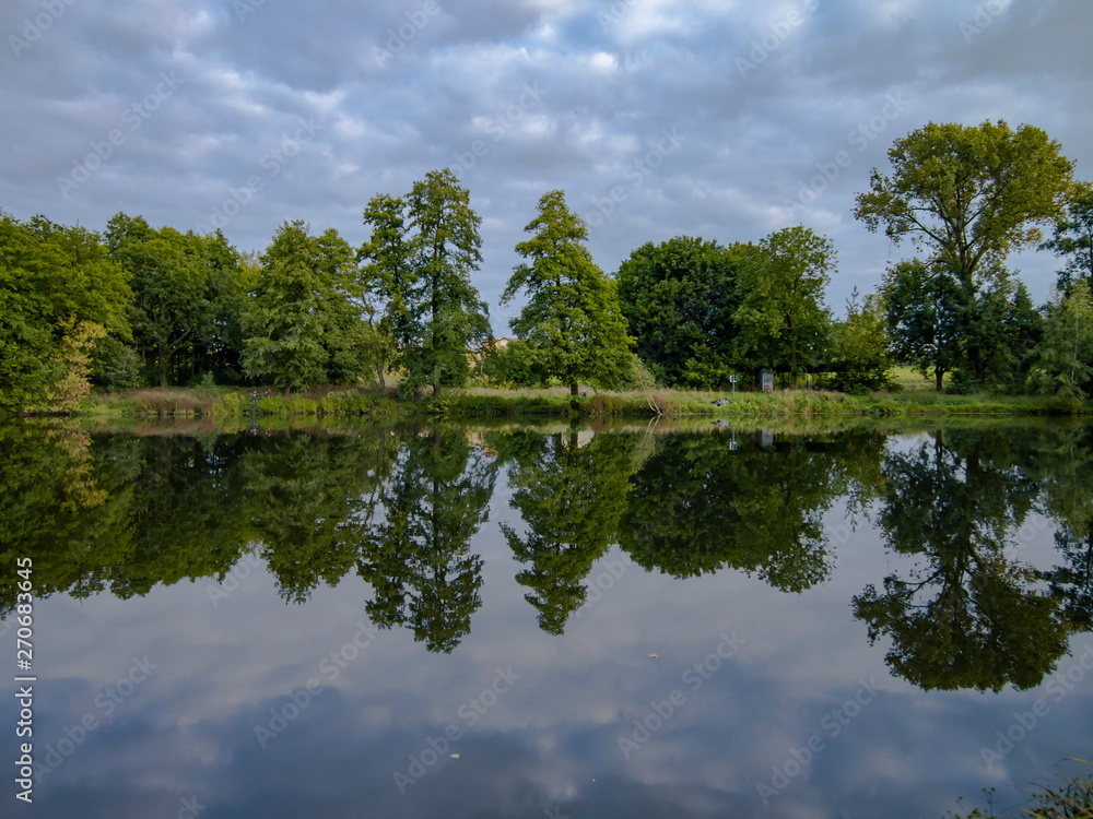 Cloudy summer day beautiful nature reflection on the lake surface