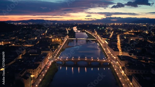 Aerial night view of Florence, Tuscany, Italy. Flying over the Arno river photo