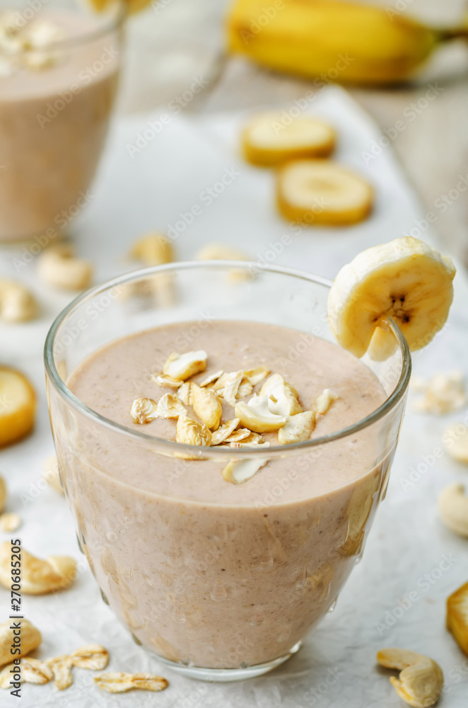 cashew banana cocoa oats smoothie on a wood background cashew banana cocoa oats smoothie on a wood background