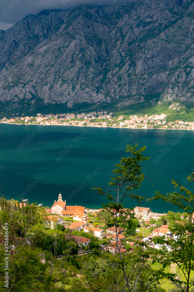Fototapeta premium Bay of Kotor from the heights. View from Mount Lovcen to the bay. View down from the observation platform on the mountain Lovcen. Mountains and bay in Montenegro. The liner near the old town of Kotor.