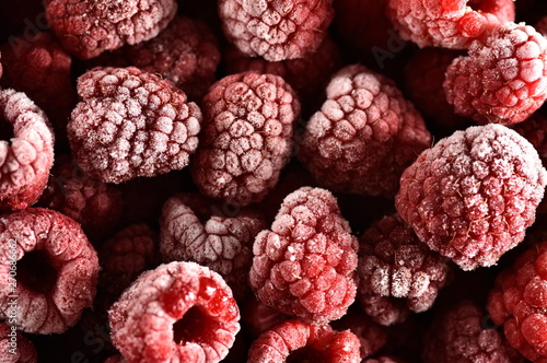 Frozen raspberries with ice coated very cold and icy