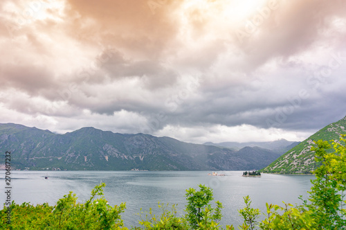 Bay of Kotor from the heights. View from Mount Lovcen to the bay. View down from the observation platform on the mountain Lovcen. Mountains and bay in Montenegro. The liner near the old town of Kotor.