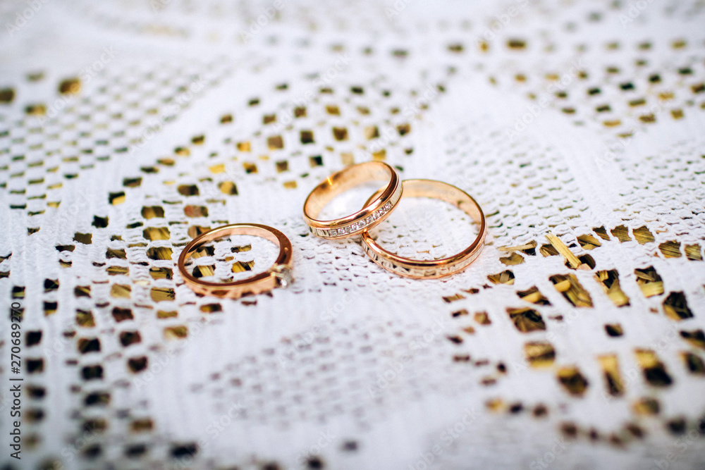 wedding rings with beautiful carvings on the sand background wedding rings with beautiful carvings on the sand background