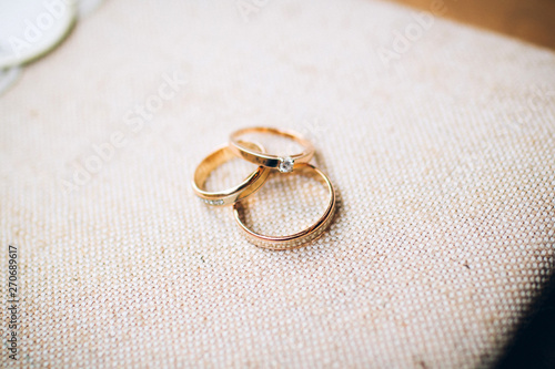 wedding rings with beautiful carvings on the sand background