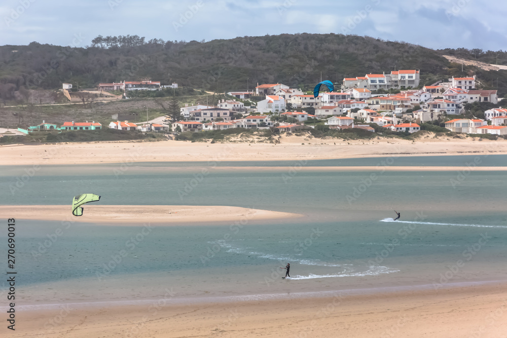 View of a professionals sports practicing extreme sports Kite-boarding at the Obidos lagoon