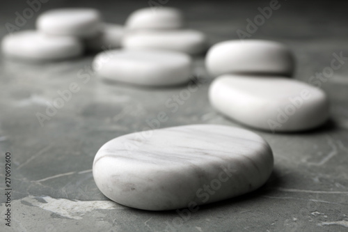 Spa stones on grey background. Space for text