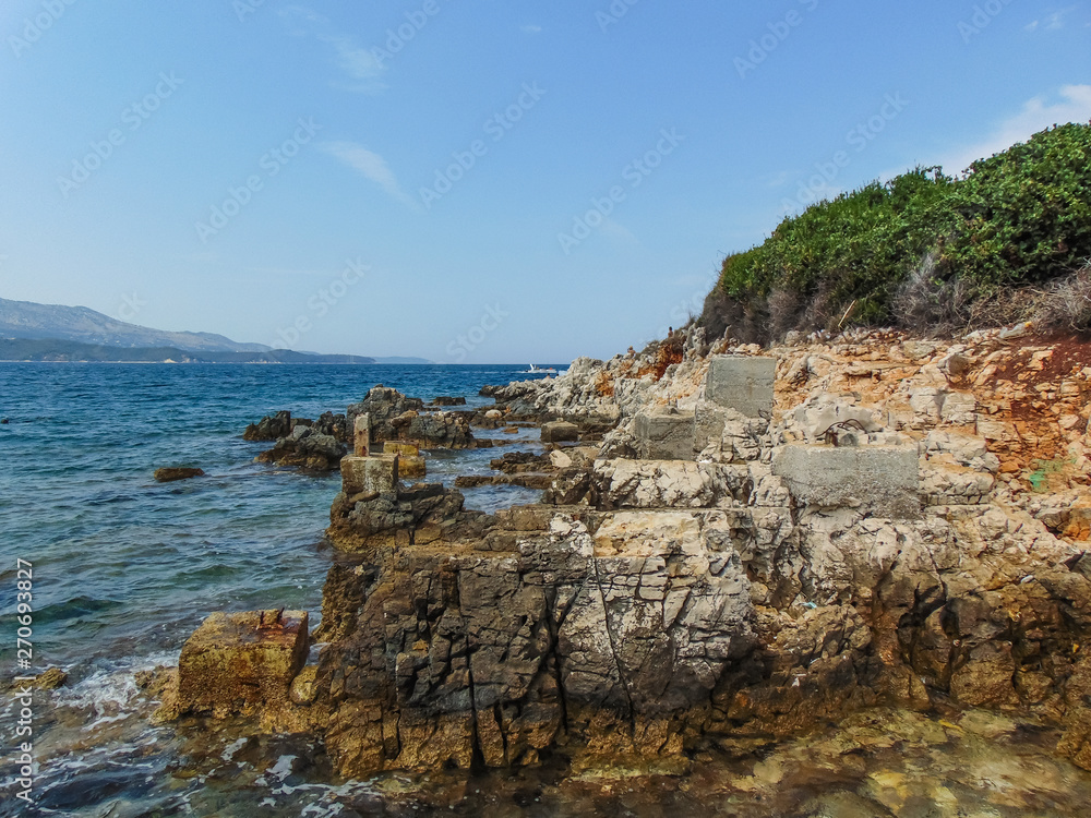 View of the rocky shore of Three island beach.