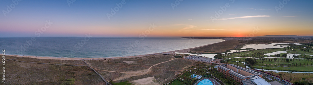 Aerial sunset seascape of Salgados beach and lagoon in Albufeira, Algarve tourism destination region, Portugal.