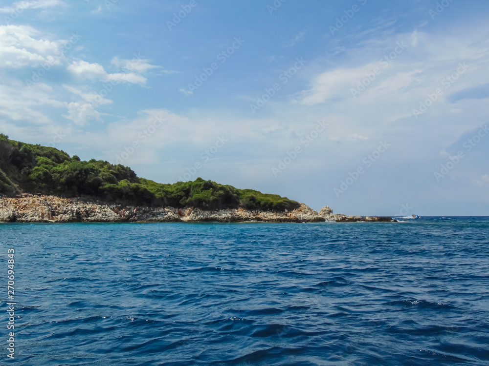 View of the rocky shore of Three island beach.