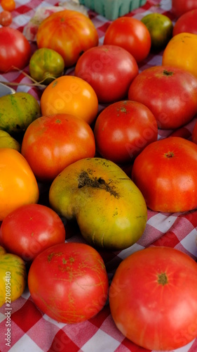 fresh tomatoes on a table at a farmers market