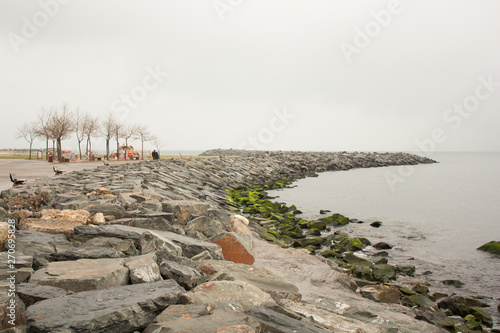 Yeşilköy rocky coastline goes along Marmara sea and has a pedestrian walkway with trainig gear and trees. photo