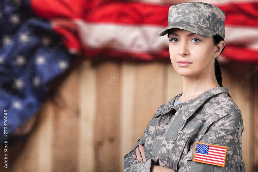 Portrait of female US army soldier on flag background Portrait of female US army soldier on flag background