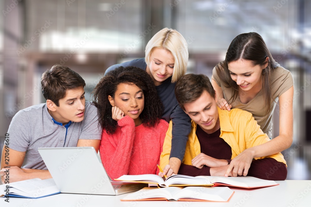 Four Young students studying subject on background Four Young students studying subject on background