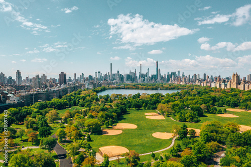 Central Park aerial view, Manhattan, New York. Park is surrounded by skyscraper. Beautiful view of the Jacqueline Kennedy Onassis Reservoir in the center of the park.