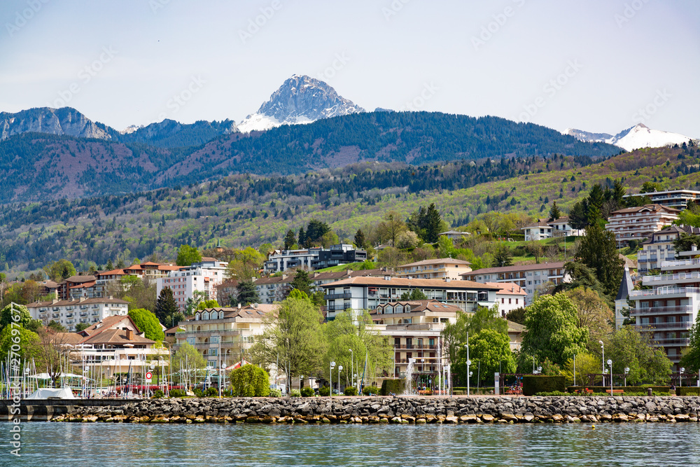 Geneva Lake shore and mountains in Evian-les-Bains city in France