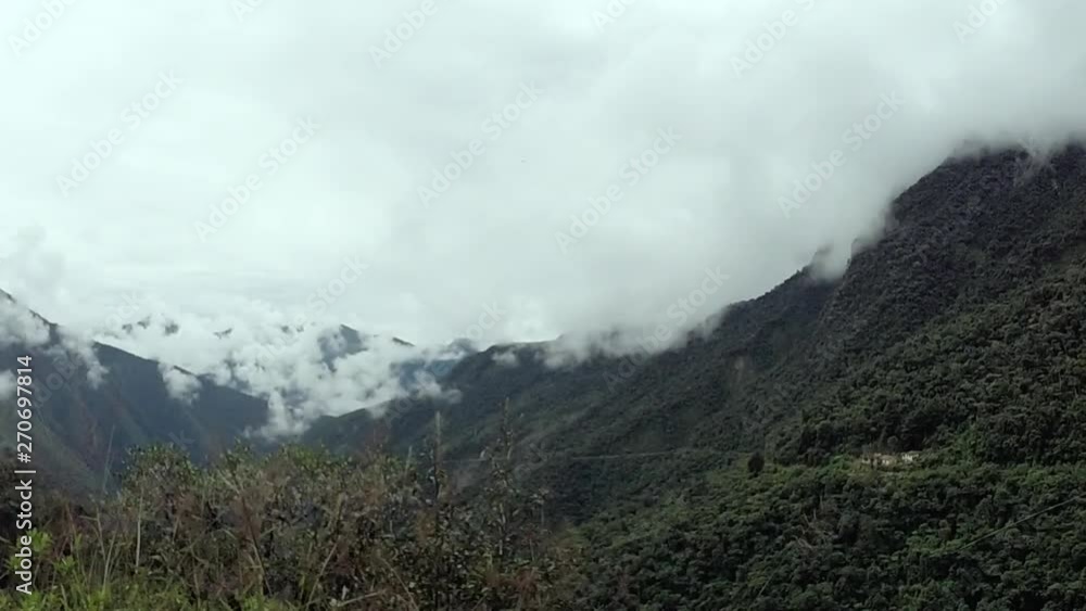 An establishing shot of clouds gathering in a forested mountainside in peru An establishing shot of clouds gathering in a forested mountainside in peru