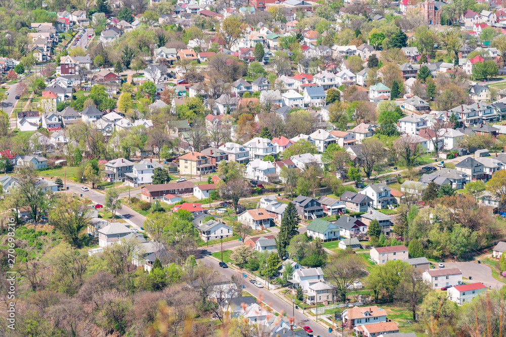 Roanoke, USA aerial high angle bird's eye view of cityscape residential neighborhood suburbs of city in Virginia during spring by mountains
