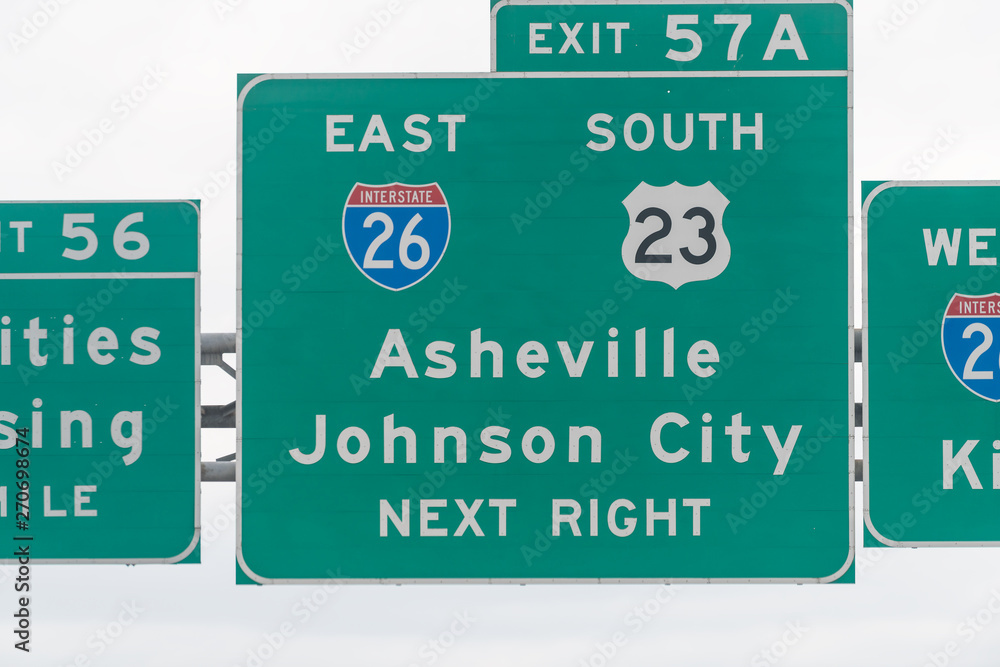 Asheville and Johnson City exit sign on highway in Tennessee on interstate 81 closeup of text Asheville and Johnson City exit sign on highway in Tennessee on interstate 81 closeup of text