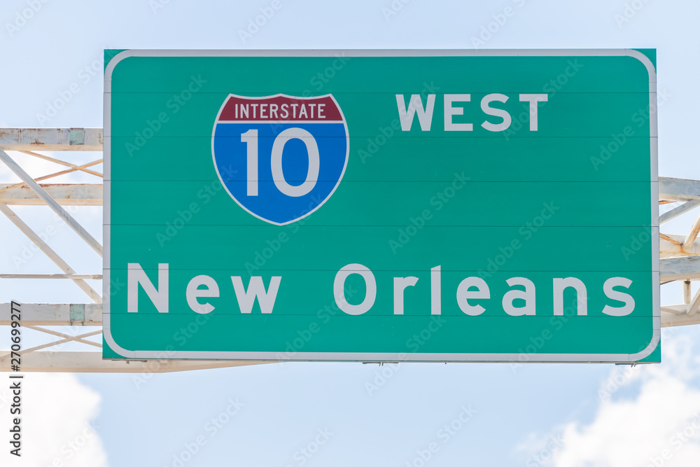 Highway road i10 west interstate 10 with direction sign and text on street for New Orleans in Lousiana