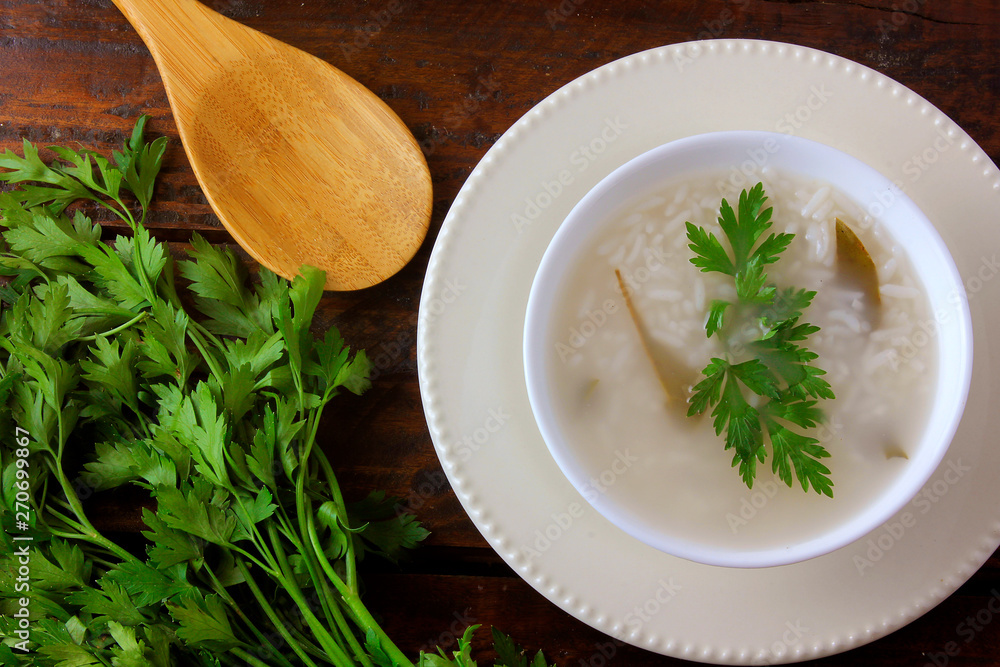 congee in ceramic bowl on rustic wooden table, traditional rice porridge typical of Asian cuisine congee in ceramic bowl on rustic wooden table, traditional rice porridge typical of Asian cuisine