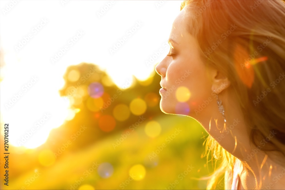 Young woman on field under sunset light Young woman on field under sunset light