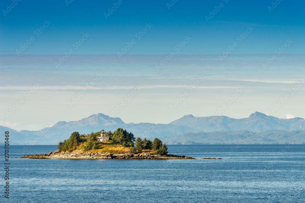 Guard Island and lighthouse at entrance to Tongass Narrows, early morning near Ketchikan, Alaska. Guard Island and lighthouse at entrance to Tongass Narrows, early morning near Ketchikan, Alaska.