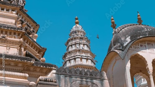 A large flock of pigeons fly over Old Rangji Temple and sit on its dome, in the city of Pushkar, India, one of the sacred pilgrimage sites in Hinduism photo