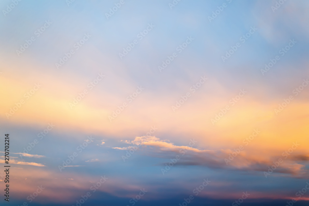 Beautifull skyscape at evening. Blue clear sunset sky with white and orange clouds. Calm background