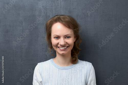 Portrait of happy young woman smiling broadly © Andrei Korzhyts